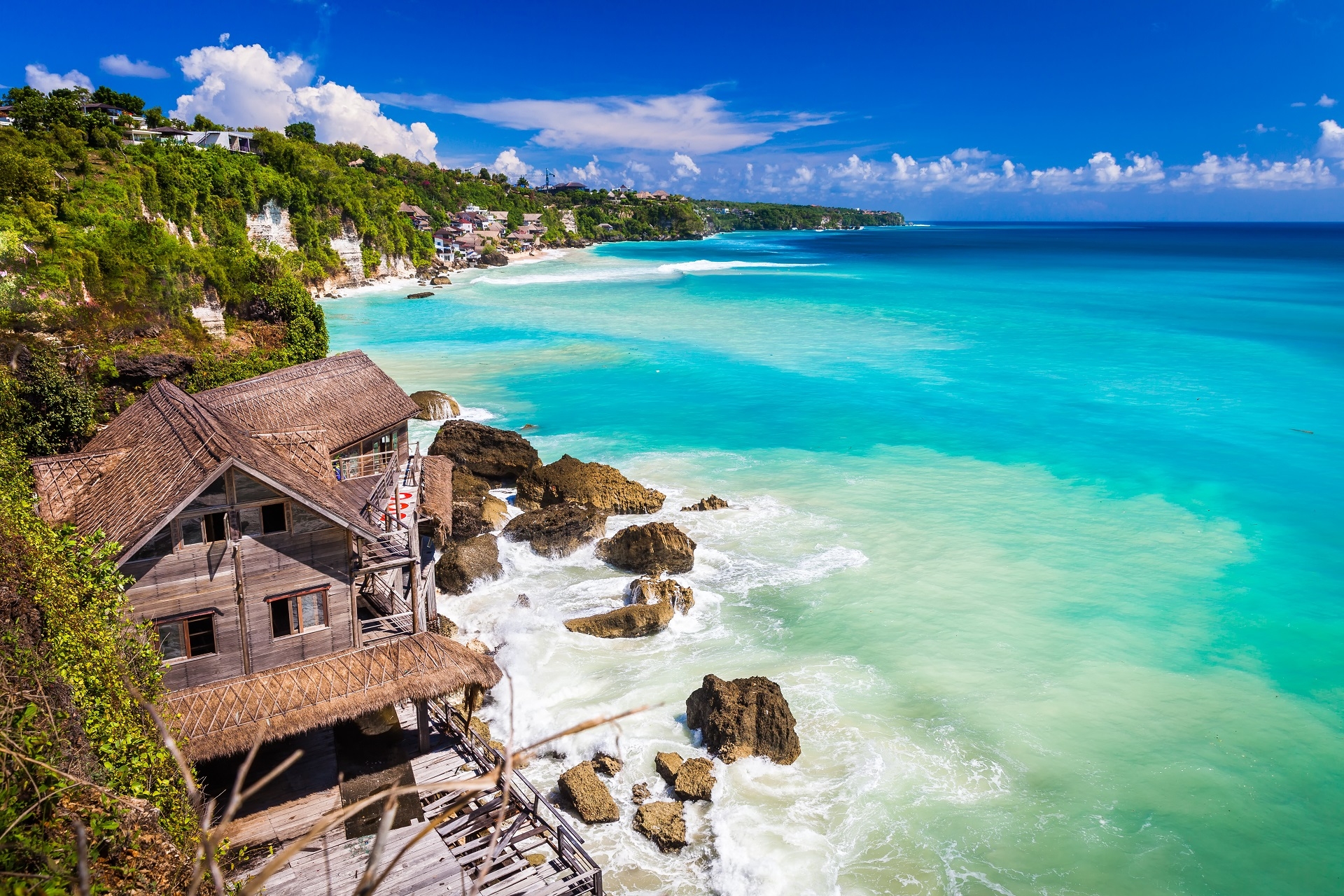 Azure beach with rocky mountains and clear water of Indian ocean at sunny day Bali