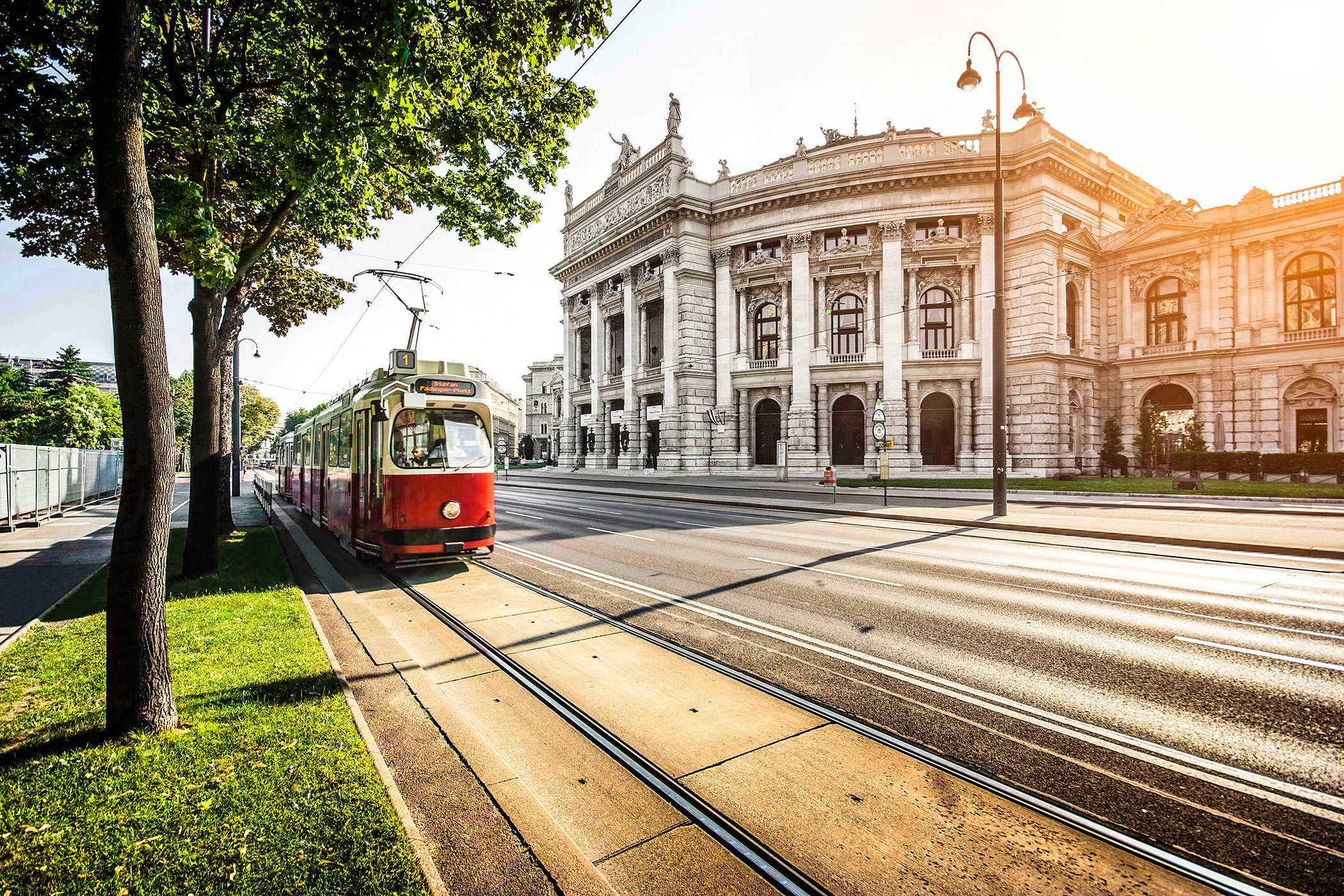 Wiener-Ringstrasse-with-tram-and-Burgtheater-at-sunrise,-Vienna-iStock_000060702174_Large-2