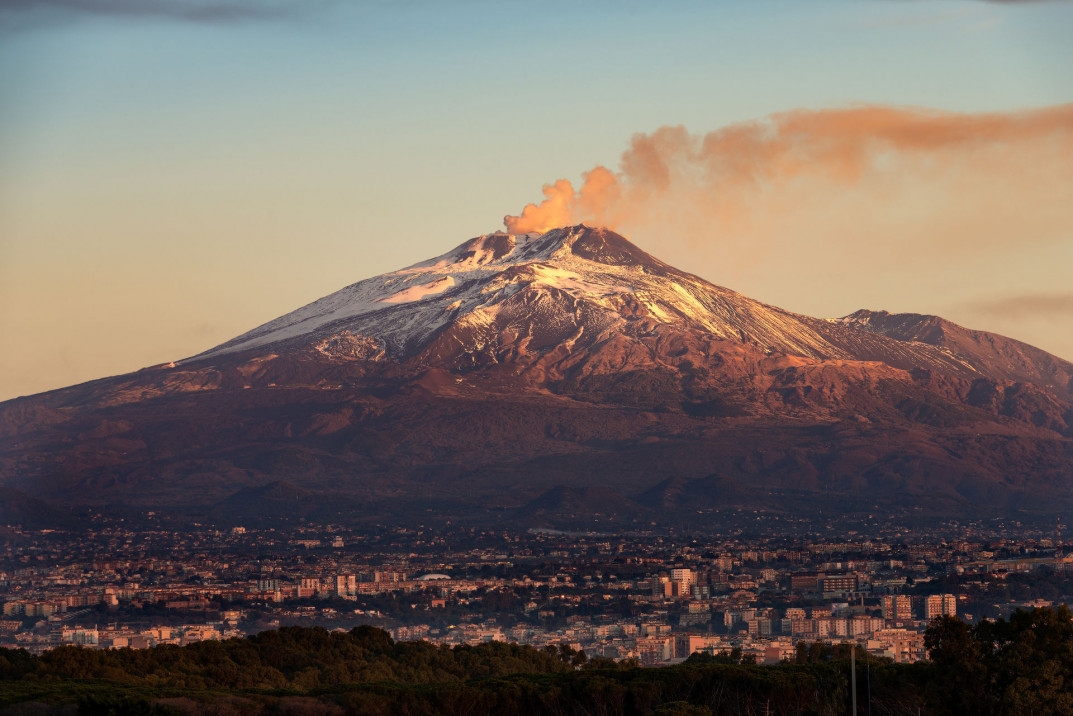 The mount Etna Volcano with smoke and the Catania city, Sicily island, Italy_shutterstock_775379560