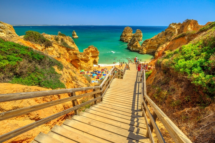  Wooden walkway to scenic Praia do Camilo in Lagos coast, Algarve, Portugal_shutterstock_1121821508_900x600.jpg